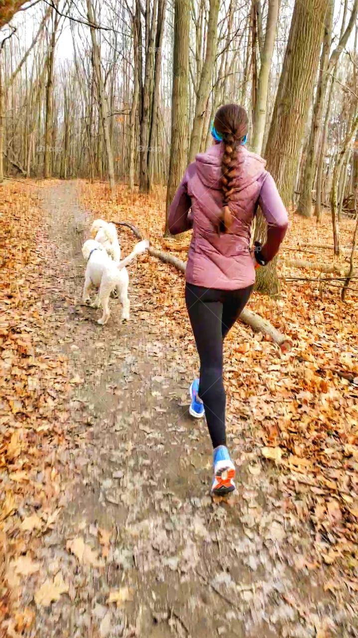 woman runs with dogs 🐕