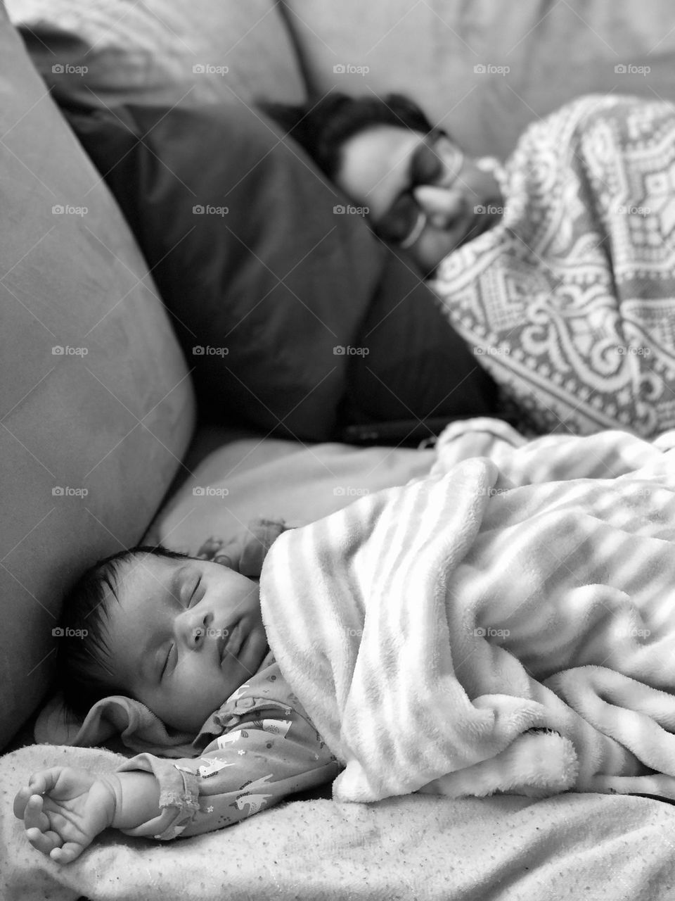 Parent and newborn baby taking a nap, tired parent naps with baby, like mother like daughter, tender moments with baby, napping with mommy