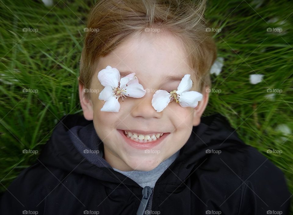 little boy lies on the grass