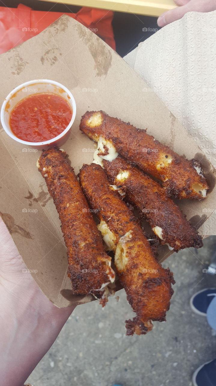 Hot, crispy deep fried Mozzerella sticks purchased from a street vendor in Williamsburg, Brooklyn, New York.