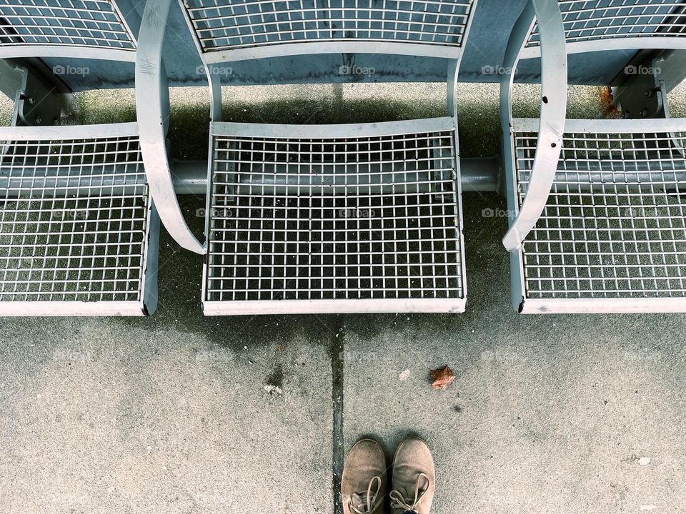 Top view of a metal bench and shoes