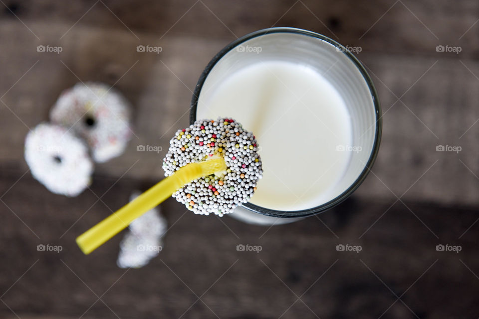 Top view of a glass of milk and sprinkle cookies