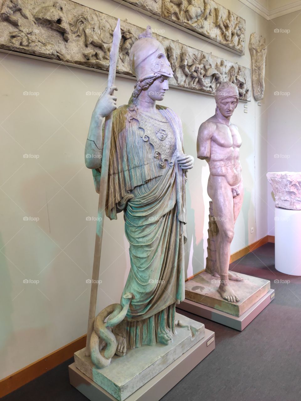 Stone statue of Greek goodess with snake