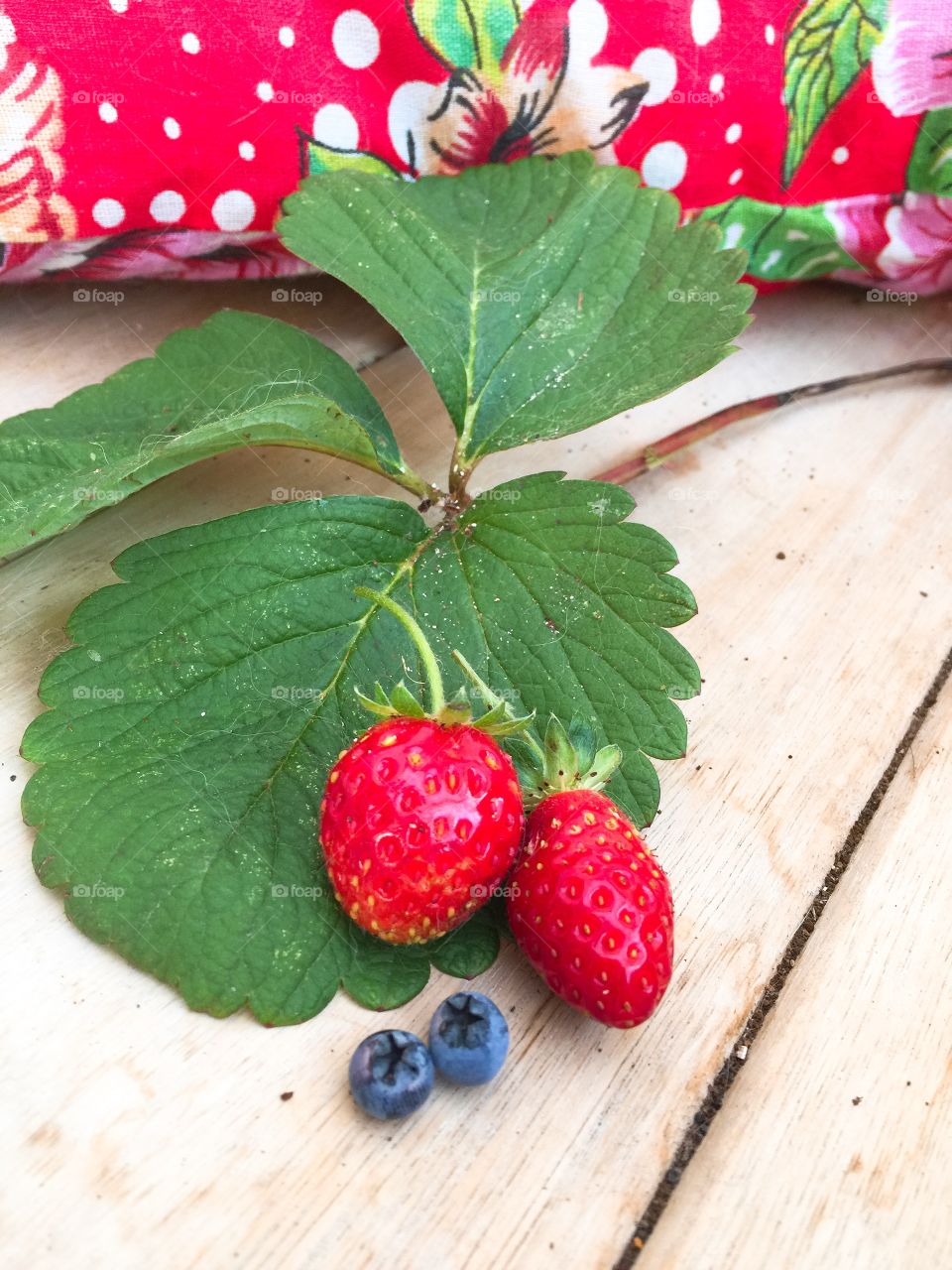 Blueberries and strawberries on wooden table