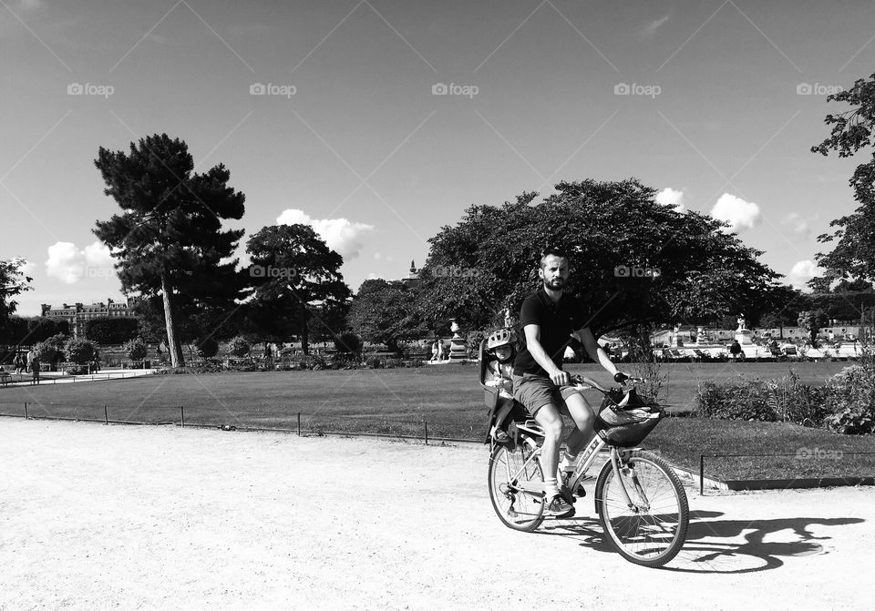 Black and white man and children on a bike