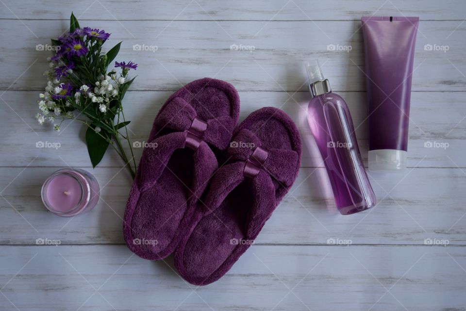 Purple Isotoner slippers on the floor