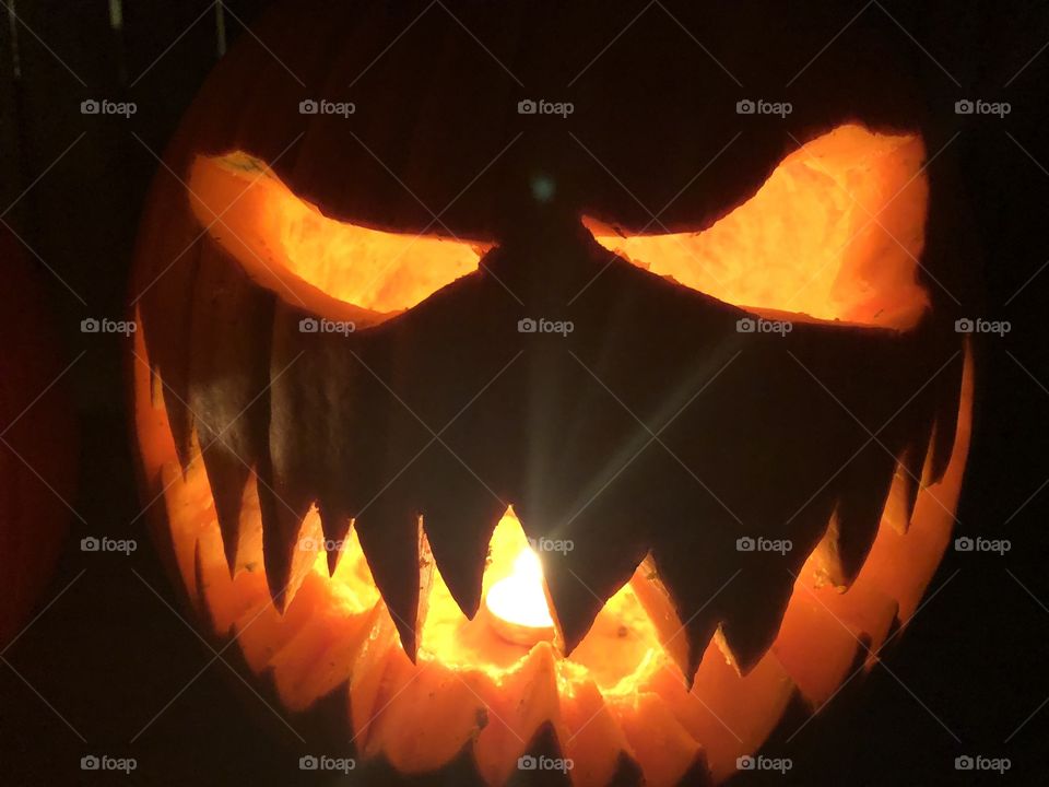 A scary carved pumpkin for Halloween. 