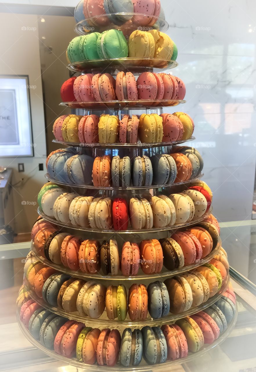 Tower of colourful macaroons on display in local bakery shop
