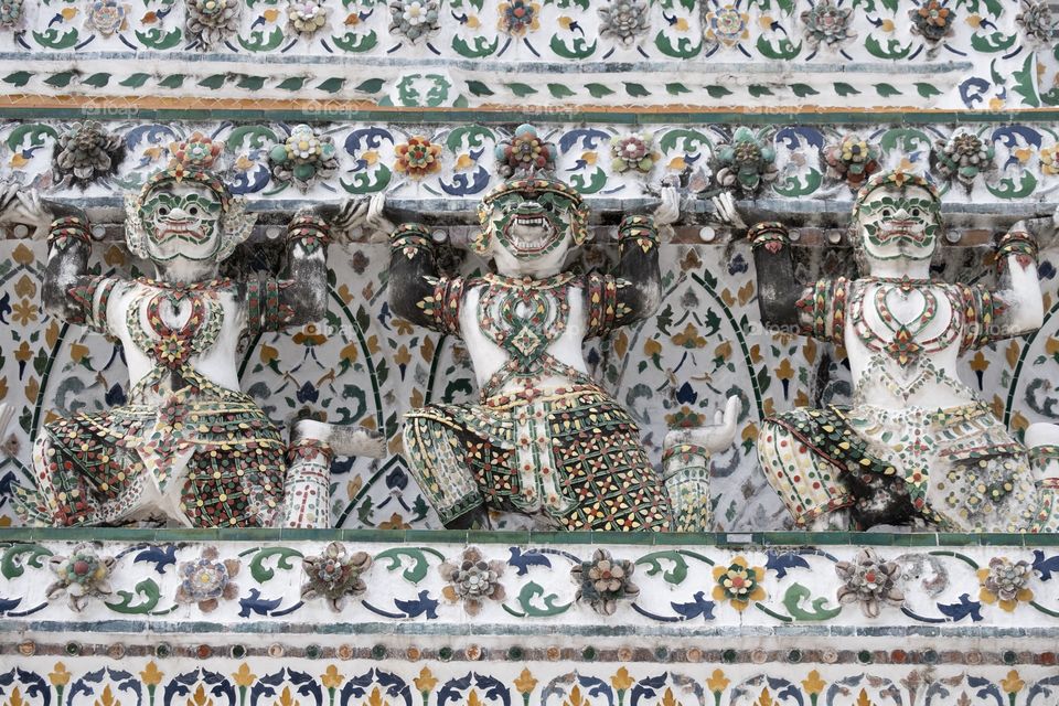 Beautiful Symmetry composition and leading line of Giant statue make the famous pagoda of  Temple of  Dawn (Wat Arun) is very interested for tourists, Bangkok Thailand