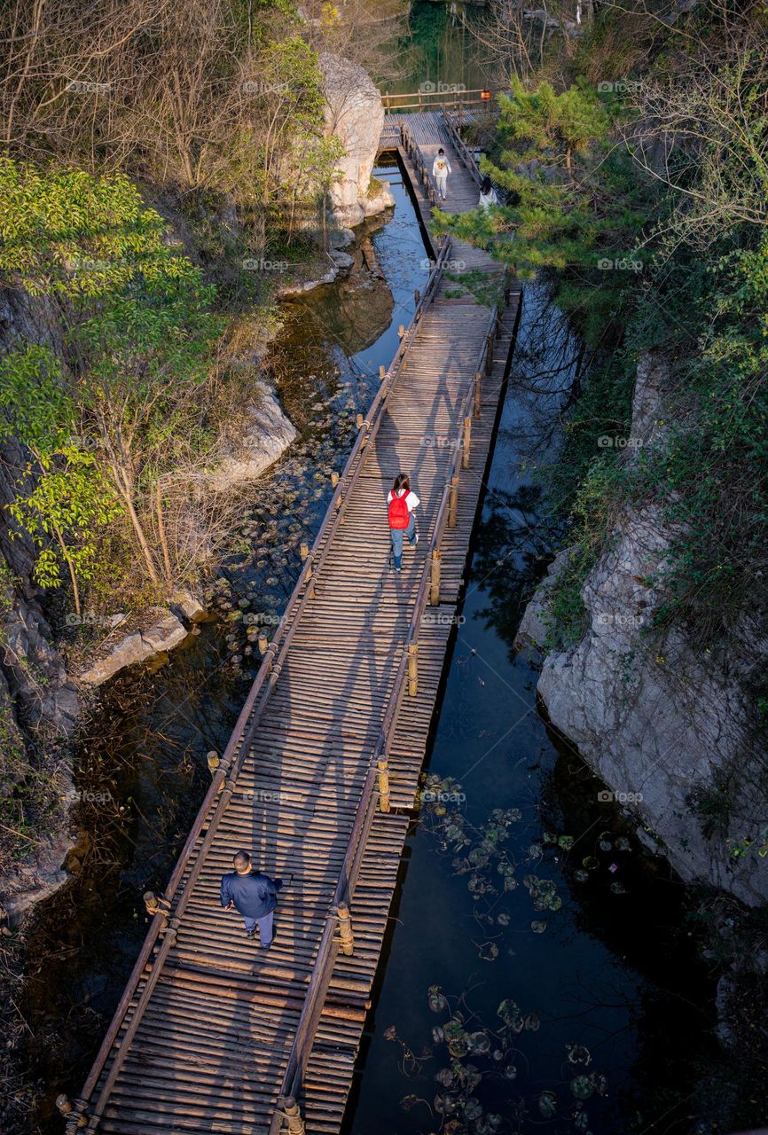 A bridge view with people walking through it.