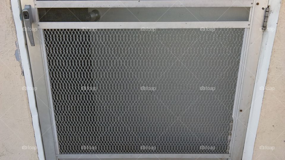 Grid pattern of a screen door.