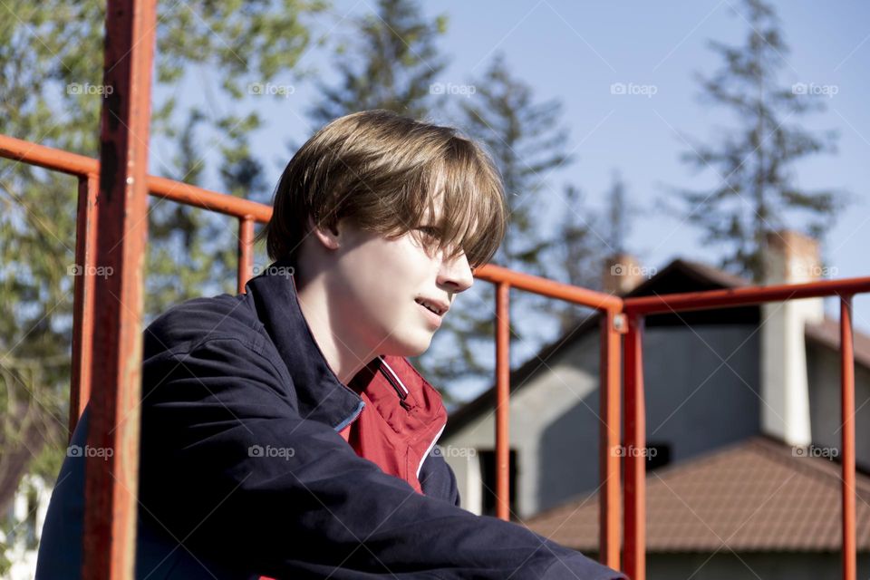 Hobbyist teenager goes in for sports, has fun and rides a skateboard in the park outdoors.