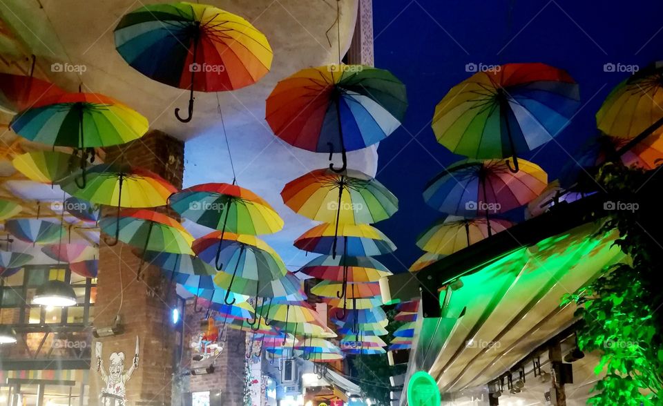 Colored umbrellas in the cafe.  Mobile photo.