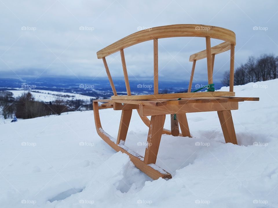 Sledges on snow and mountains in the background