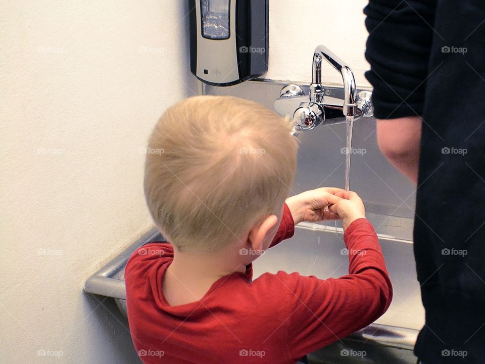 Boy washing his hands