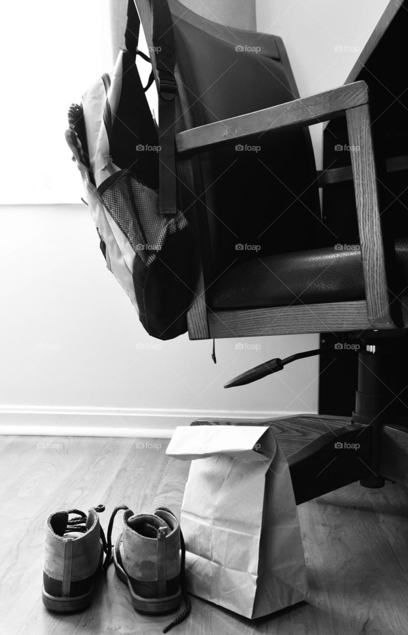 Book bag, shoes, and paper bag lunch laid out and ready for school