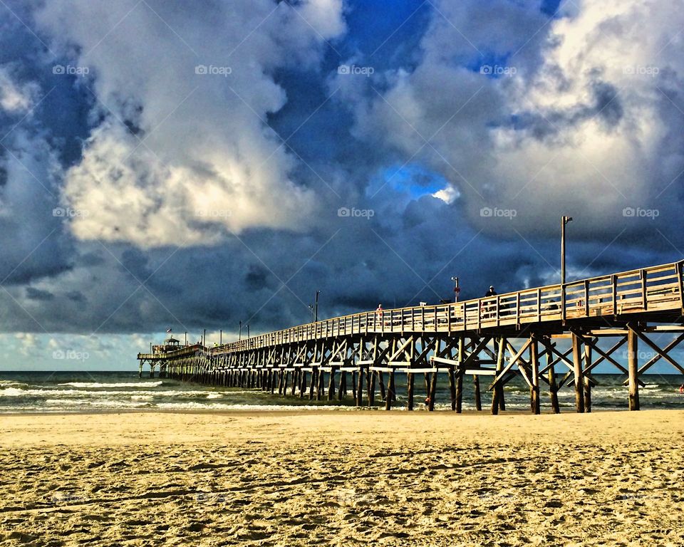 Storm clouds over the ocean pier and sandy beach at cherry grove South Carolina 
