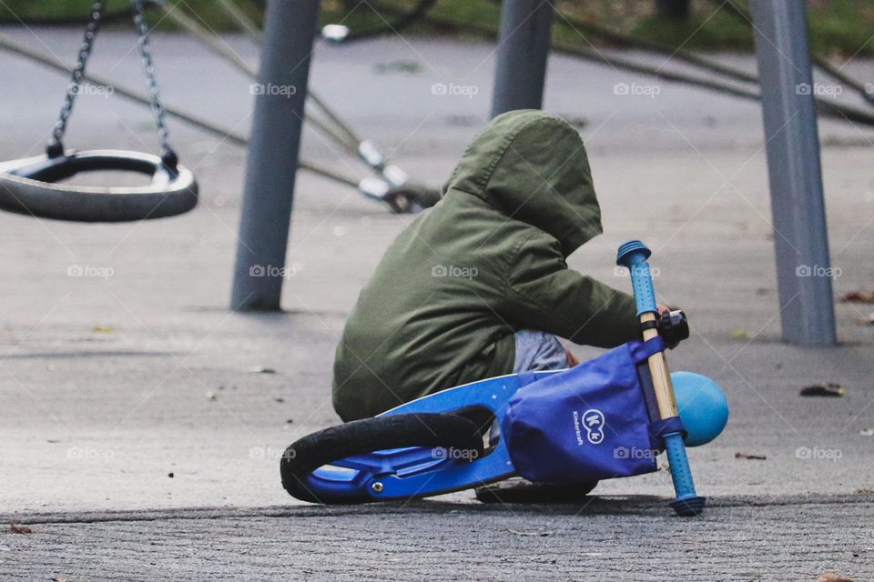 A child and a blue bike