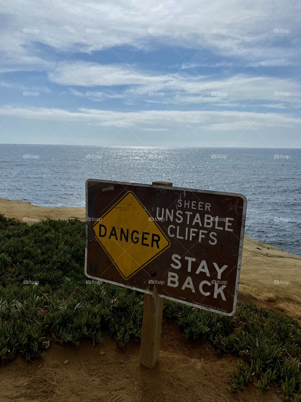 Danger sign in front of the beach at Sunset Cliffs in San Diego California 