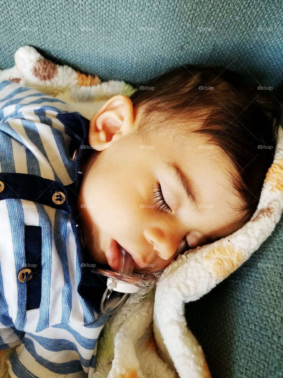 Boy sleeping with soother in his mouth