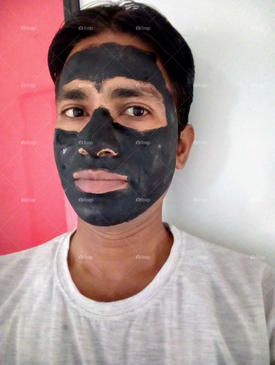 Applying black mud mask