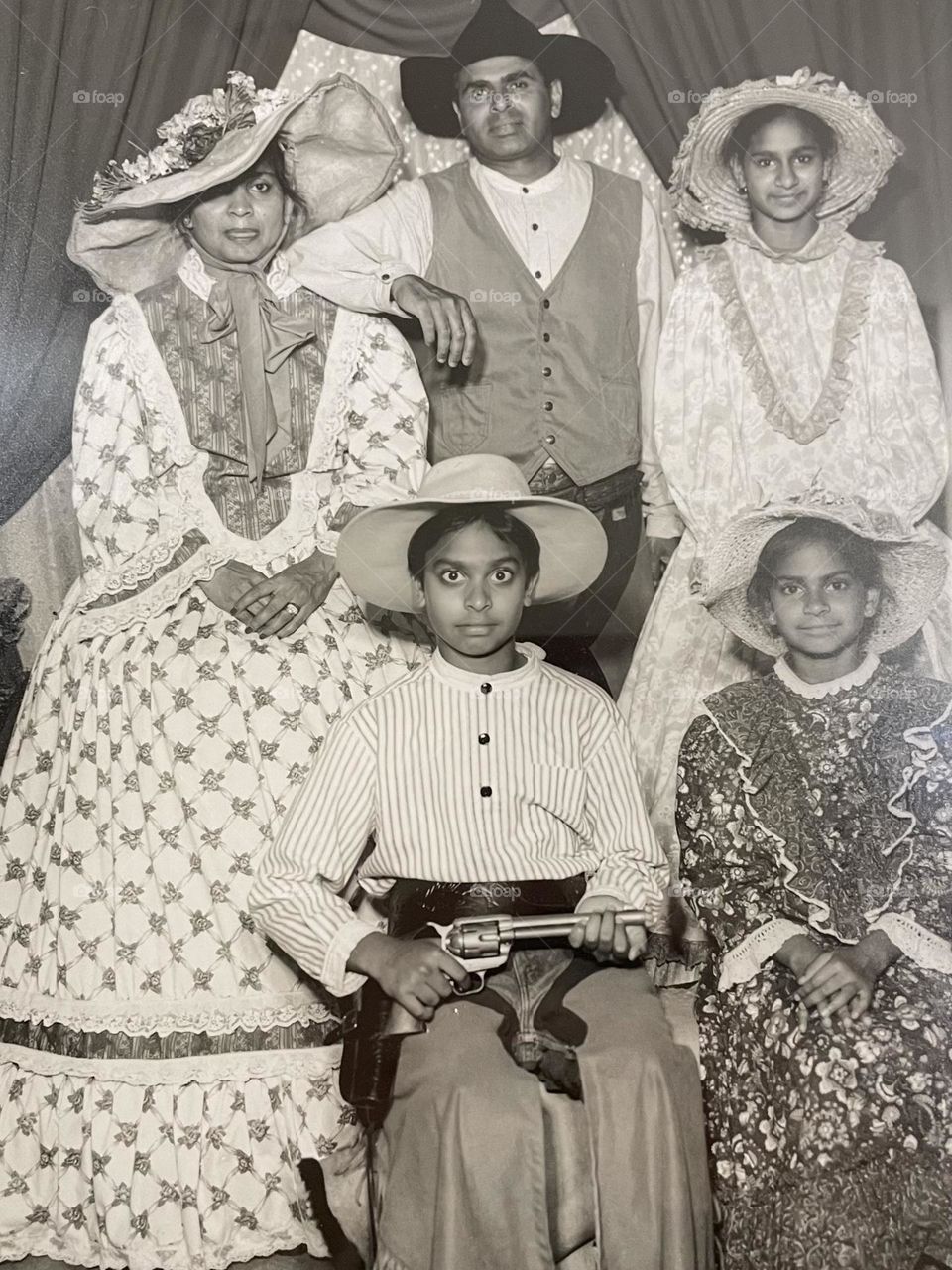 Funny family portrait at amusement park, taking funny family photos with kids, cute family portrait in western style clothing