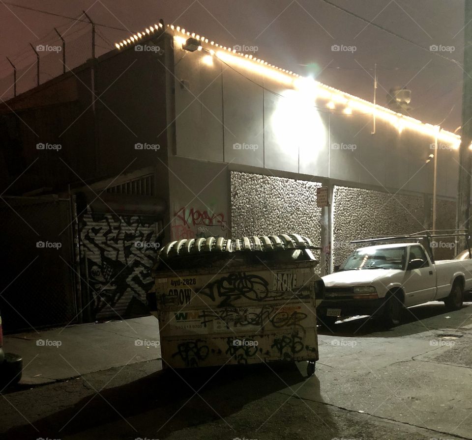 A graffitied up dumpster had been rolled right into the middle of 26th street and Telegraph Ave in Oakland to await trash pickup the next morning.