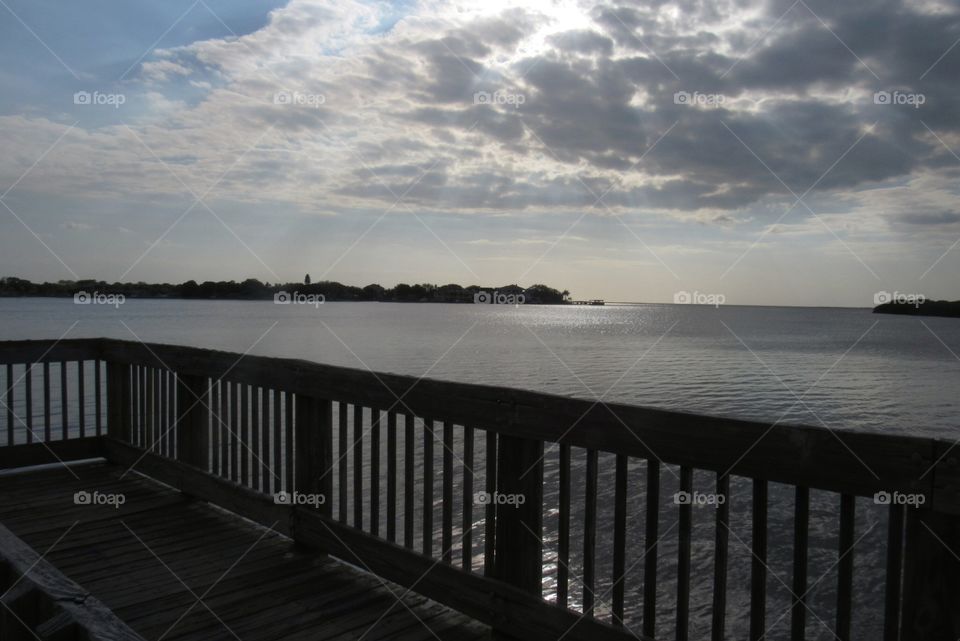 Fishing pier in Florida on partially cloudy day