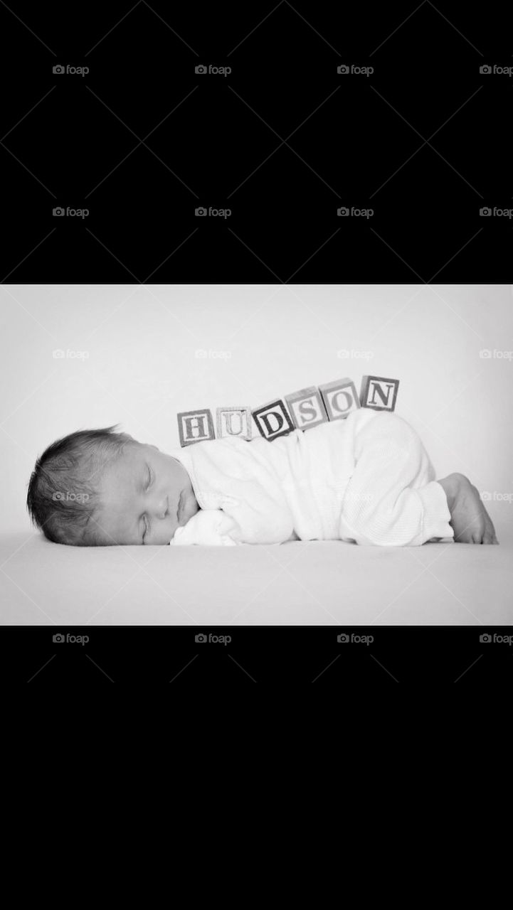 Baby boy with blocks on his back