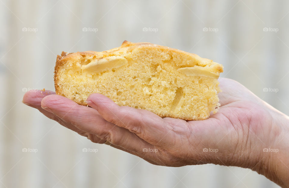 Apple cake in the palm of a woman's hand