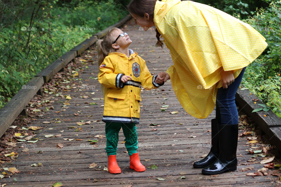 a woman holding hand with a child