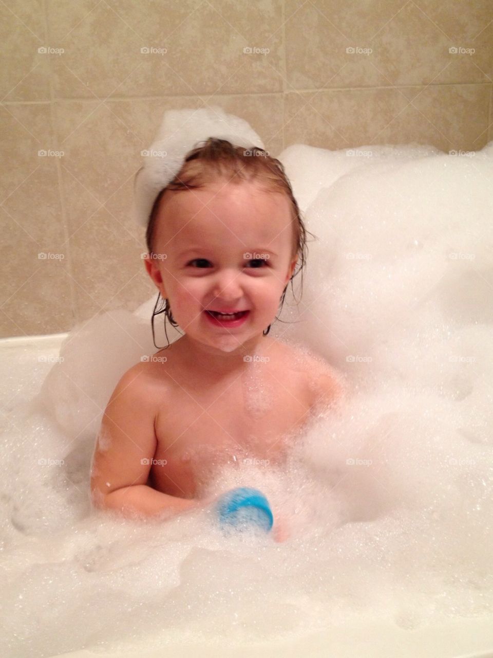 Baby bubble bath. Baby taking a bubble bath