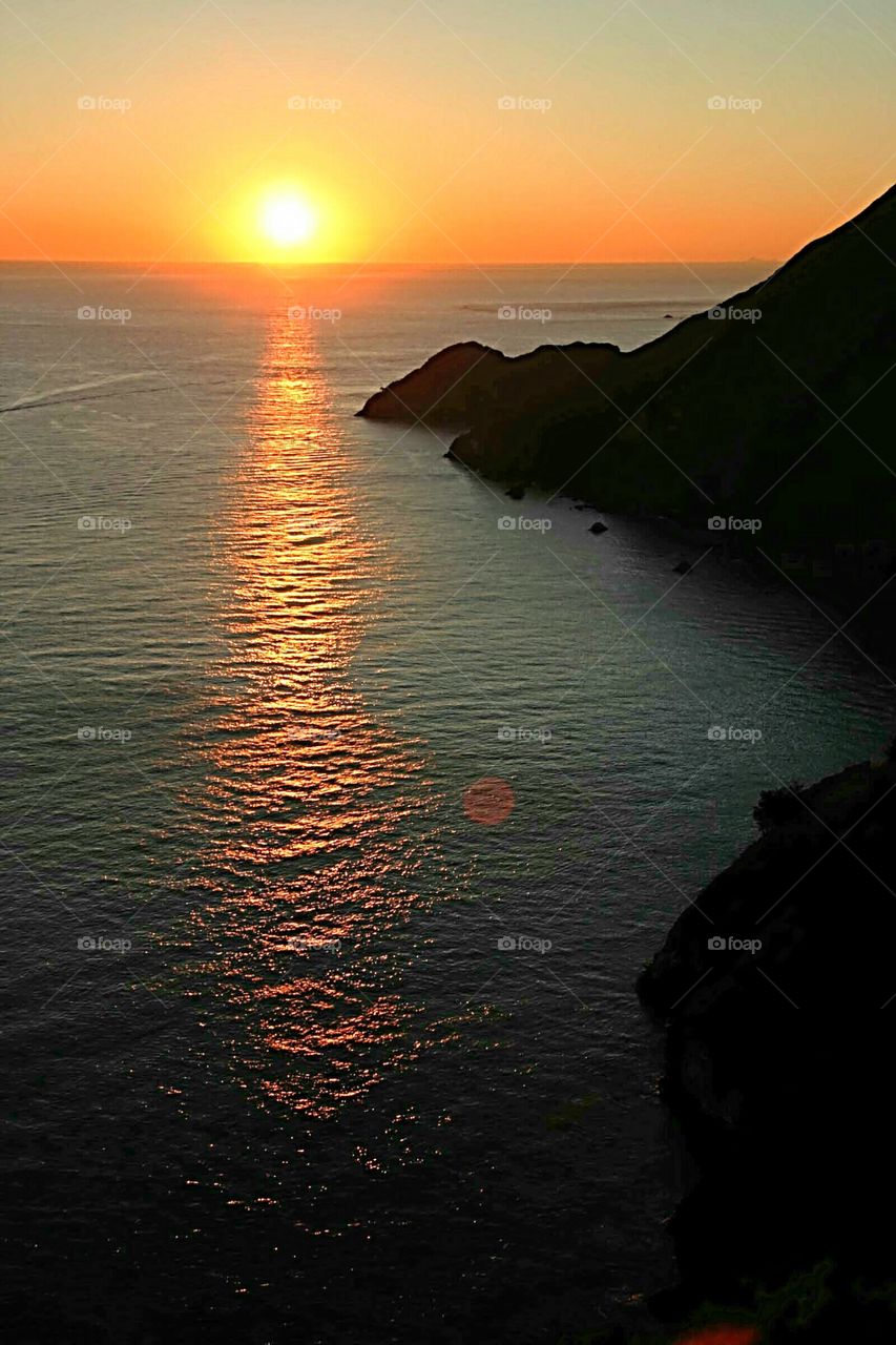 Sun reflecting on sea at sunset