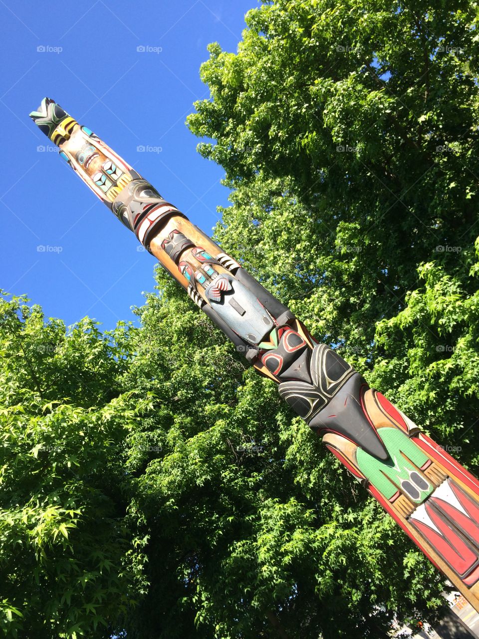 Looking Up at Totem Pole . Totem pole against sky 