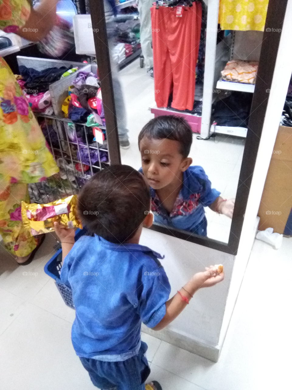 Little boy playing with mirror.