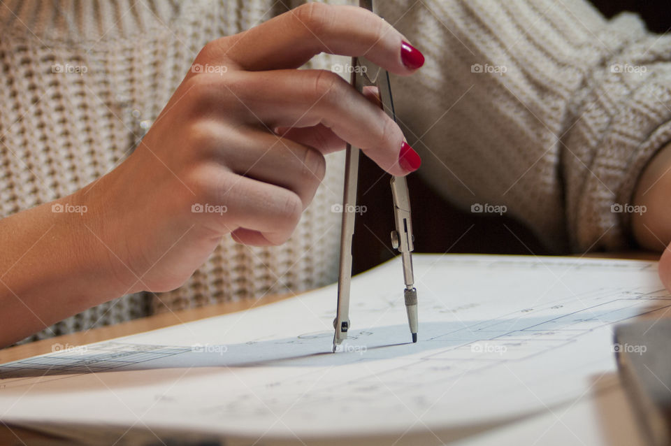 Girl draws a drawing compass