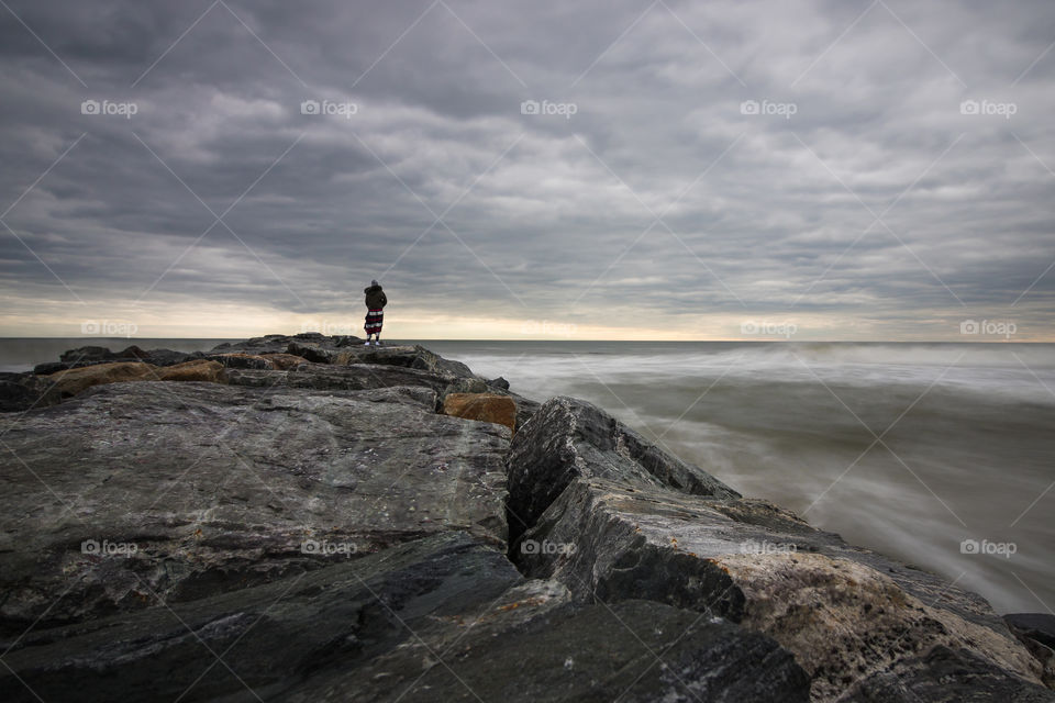 Silhouette of a person on a jetty. 