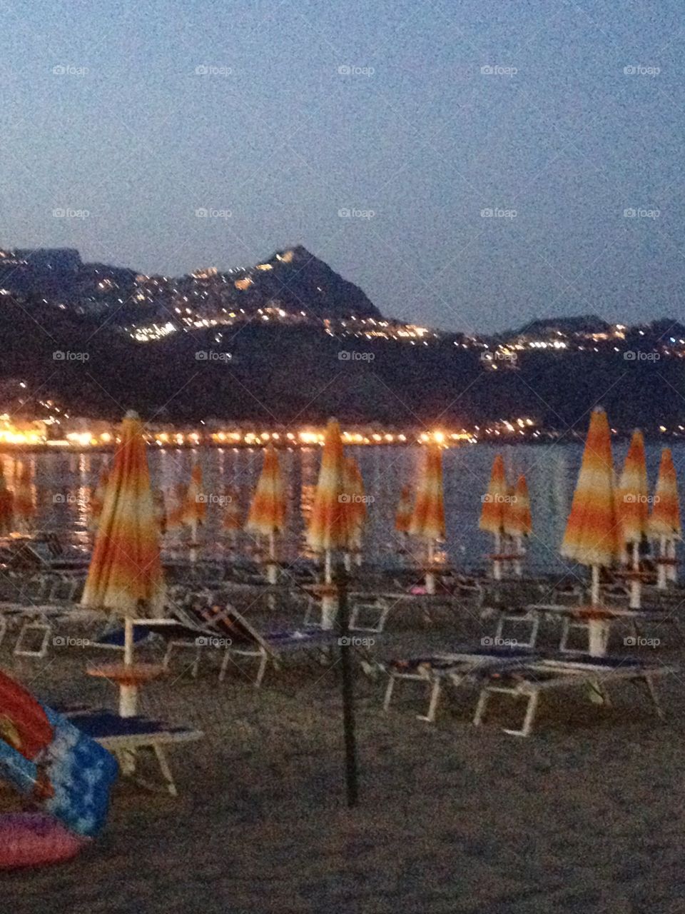 Taormina, Sicily, at night from the beach. Town in the mountains. Lights at night. 