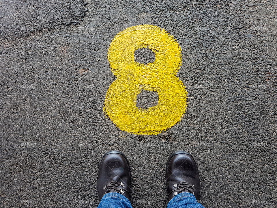 standing at a yellow number 8