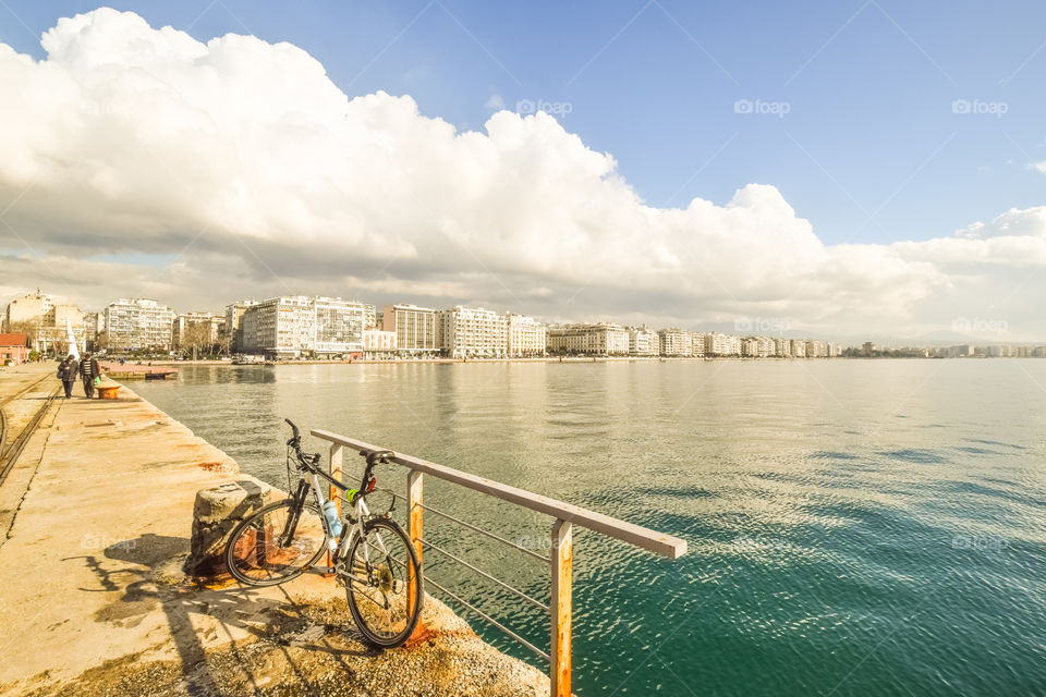 Cityscape In Overcast And A Parked Bicycle On The Seafront
