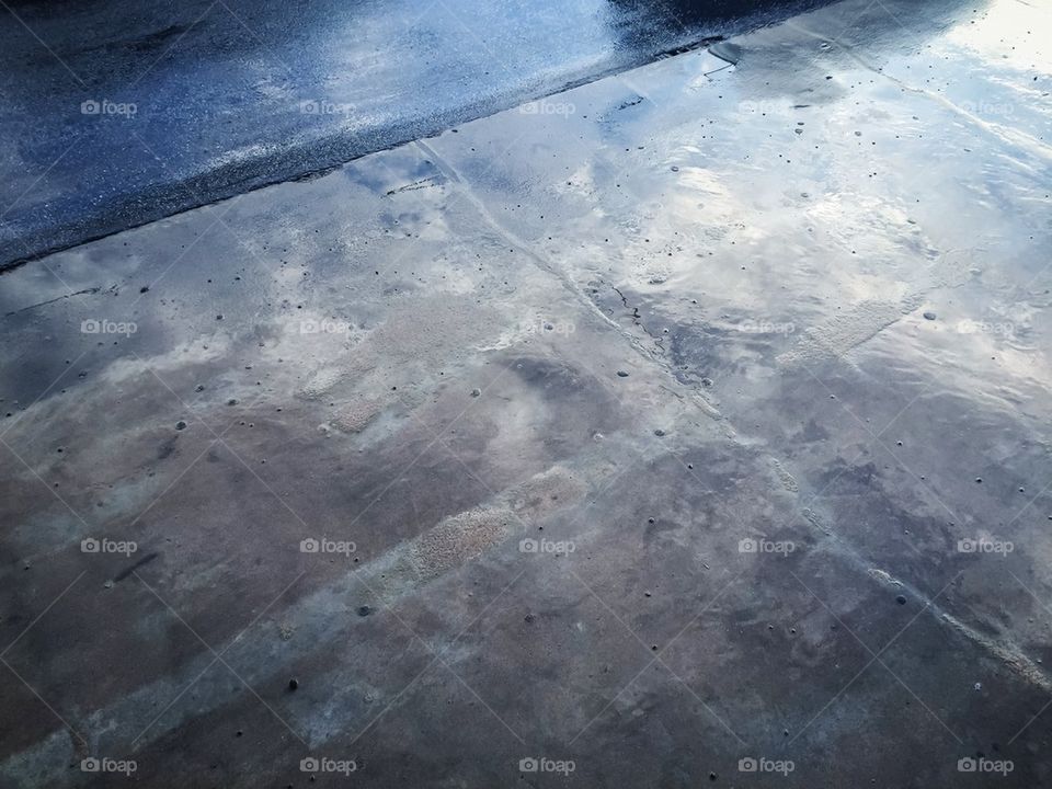 Wet street with revelations of car