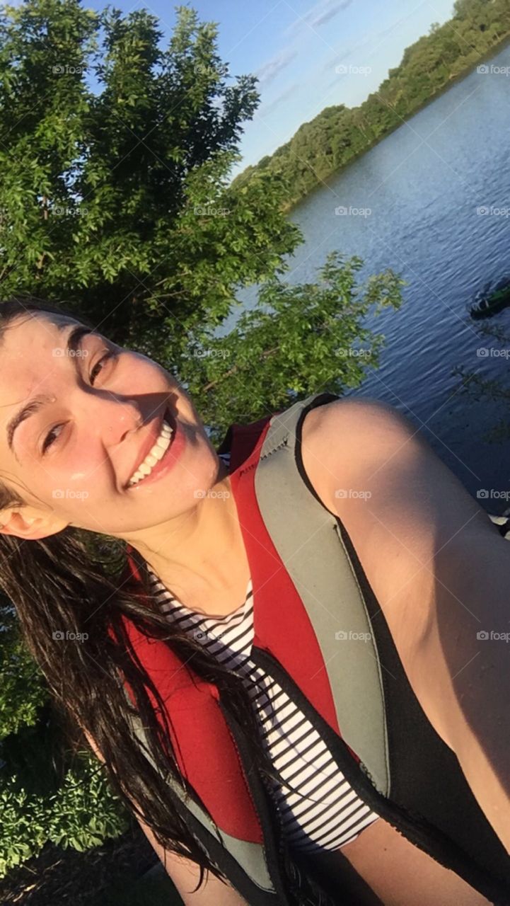 Girl taking a selfie after a day on the lake. 