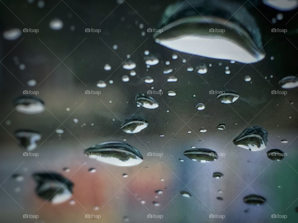 Rain drops close up in a car window 
