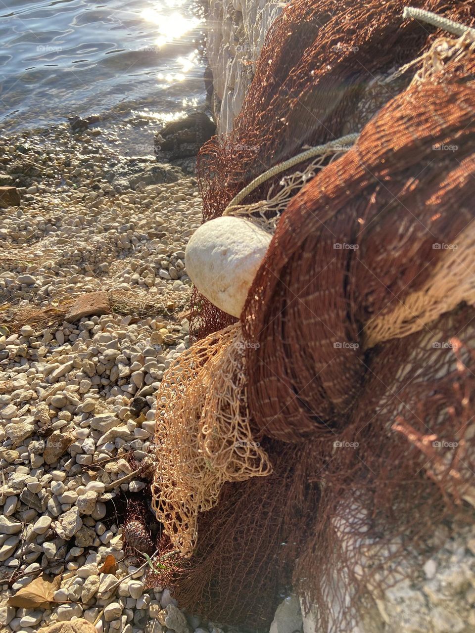 Fishing nets by a sparkling sea.