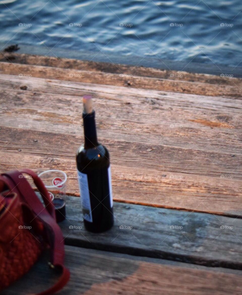 People enjoying wine in the evening sat near the Douro river 