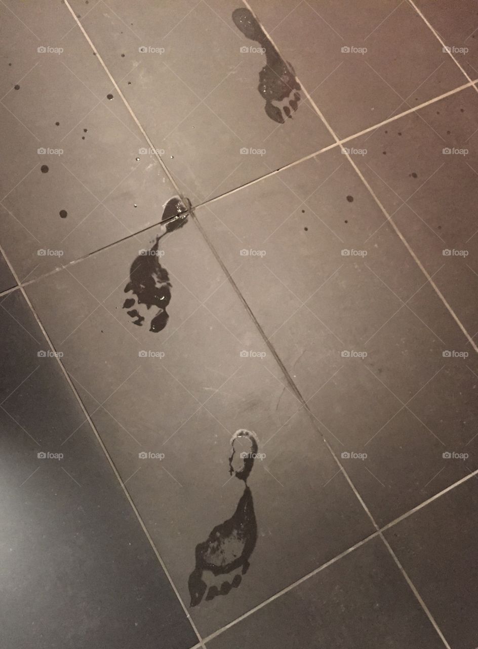 Wet footsteps on tile floor