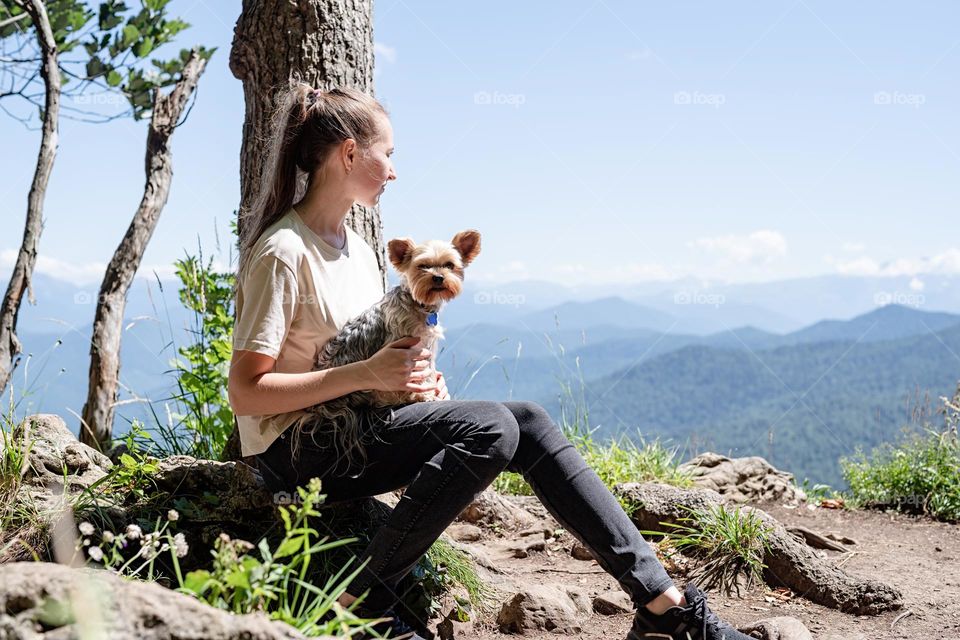 happy caucasian woman in mountain with her dog