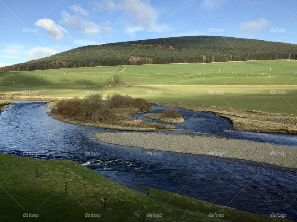 River by the hills