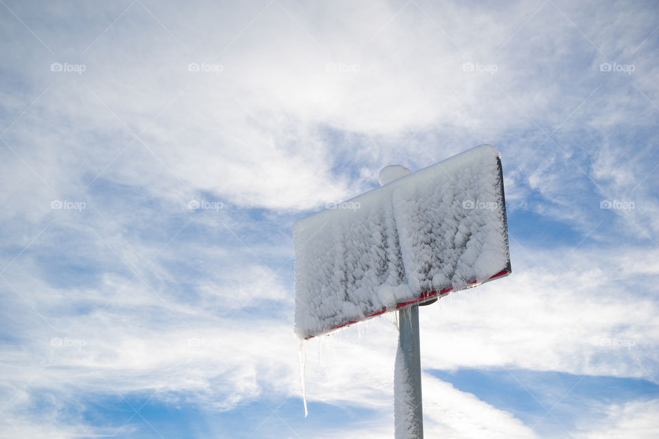 snow and ice covered street sign
