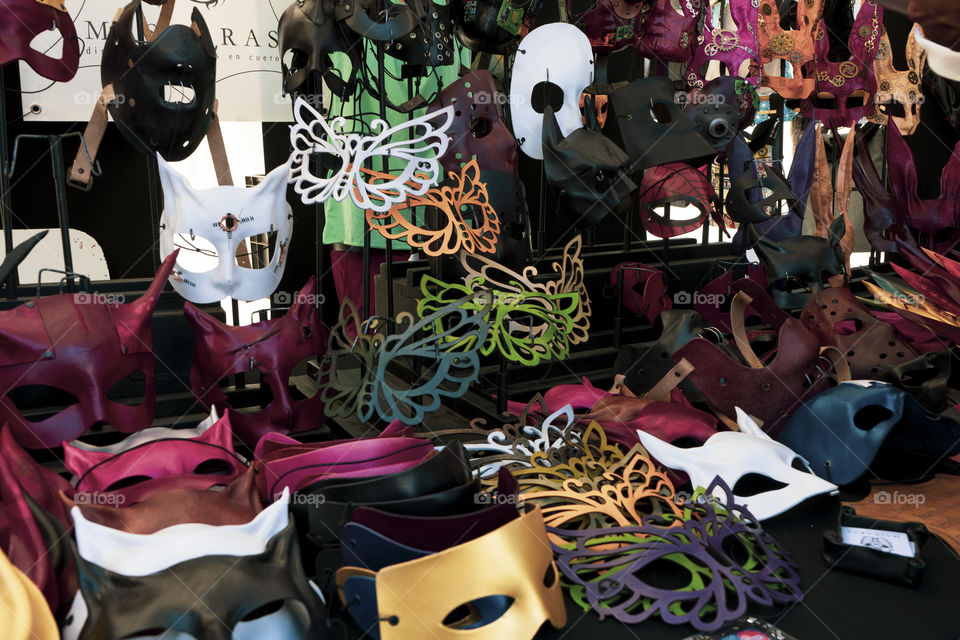 Carnival masks in a stall in Barcelona.

All colored masks in a wood-colored stan and dark skin.